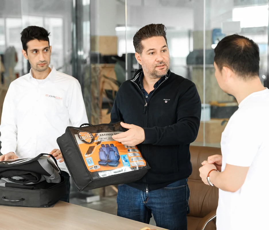 JohnElina specialists reviewing products at a supplier factory