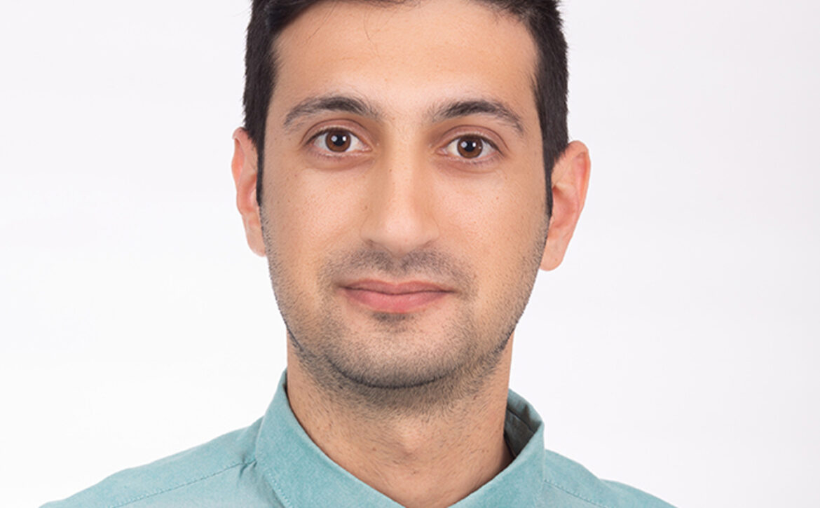 group of smiling builders in hardhats outdoors